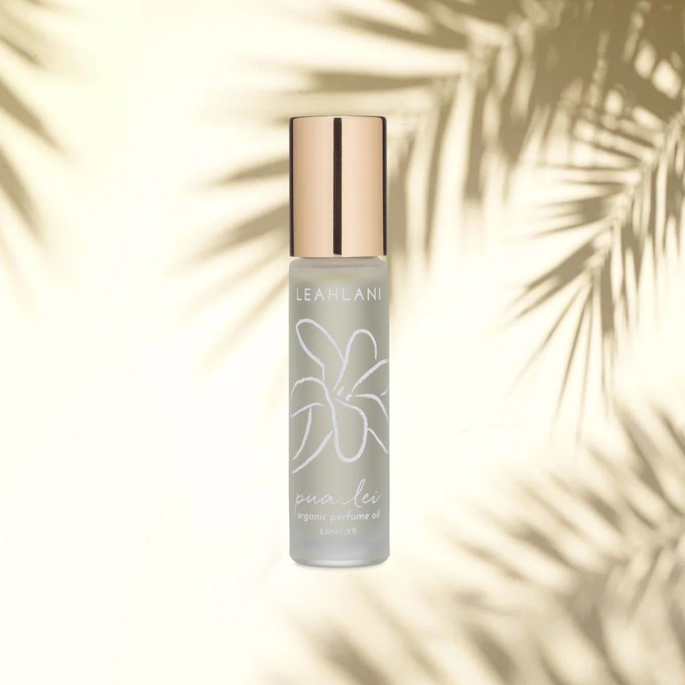 Leahlani Pua Lei Perfume Oil 9 ml – Flakon vor hellem Hintergrund mit Palmblatt-Schatten